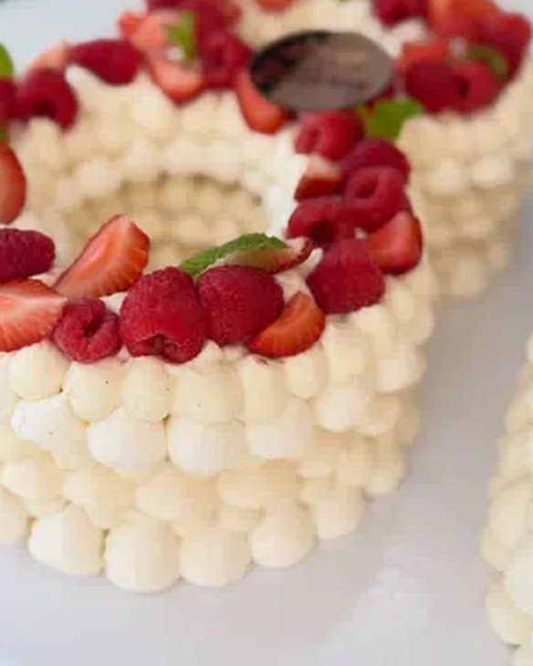 Cream cake topped with fresh strawberries and raspberries