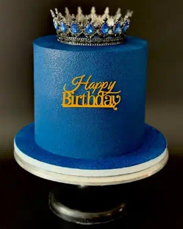 Royal blue birthday cake with silver crown topper