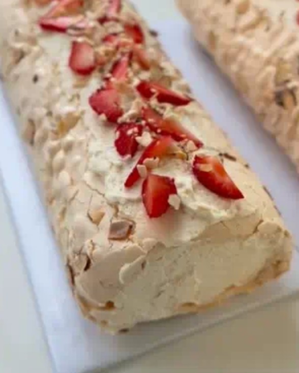 Cream roll topped with strawberries and toasted almonds